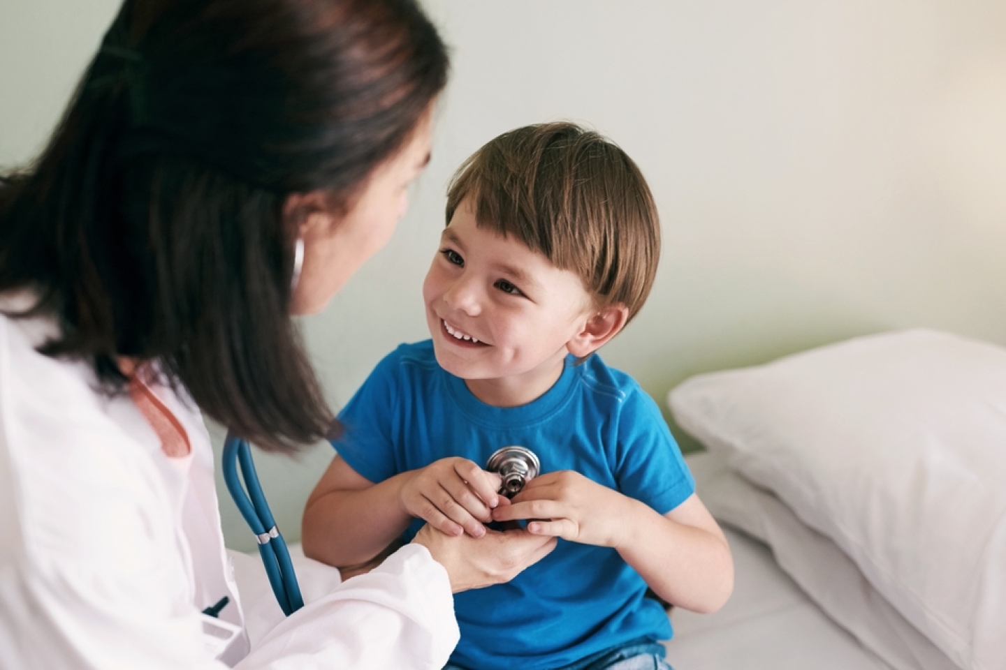 Doctor, stethoscope and child in hospital for healthcare, health and wellness with medical exam.